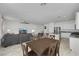 Open-concept view of a dining area leading into the kitchen and living space, with ample seating at 3018 Carothers Ct, North Las Vegas, NV 89032