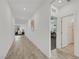 Hallway with wood floors, white walls, and bathroom, den, and living room entrances at 3018 Carothers Ct, North Las Vegas, NV 89032