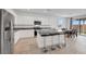 Modern kitchen features white cabinets, stainless steel appliances, and a large island with barstool seating at 3018 Carothers Ct, North Las Vegas, NV 89032