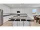 Bright kitchen with white cabinets, stainless steel appliances, and a center island with barstools at 3018 Carothers Ct, North Las Vegas, NV 89032