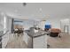 Open-concept kitchen with a center island open to the living room and dining area at 3018 Carothers Ct, North Las Vegas, NV 89032