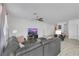 Spacious living room with contemporary furnishings, a ceiling fan, and ample natural light at 3018 Carothers Ct, North Las Vegas, NV 89032