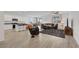 Open-concept living room featuring wood flooring and stainless steel appliances at 3018 Carothers Ct, North Las Vegas, NV 89032