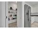 A well-stocked pantry adjacent to a modern kitchen with stainless steel refrigerator and white cabinets at 3018 Carothers Ct, North Las Vegas, NV 89032
