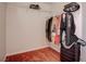 Organized closet with wire shelving, hanging clothes, and a suitcase at 3025 Treesdale Dr, Las Vegas, NV 89134