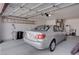 Garage featuring a parked car, storage, and garage door at 3025 Treesdale Dr, Las Vegas, NV 89134