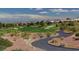 Scenic view of a golf course in Sun City Summerlin with desert landscaping and views of the city skyline at 3025 Treesdale Dr, Las Vegas, NV 89134