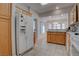 Spacious kitchen featuring white appliances, wood cabinets, and tile floors, with a bright breakfast nook at 3025 Treesdale Dr, Las Vegas, NV 89134