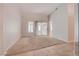 Spacious living room featuring carpet flooring and a sliding glass door at 3025 Treesdale Dr, Las Vegas, NV 89134