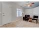 Tile floor living room with chair, side table and shuttered window at 3025 Treesdale Dr, Las Vegas, NV 89134