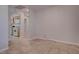 Neutral-toned living room with tile floors and a glimpse into the kitchen at 3025 Treesdale Dr, Las Vegas, NV 89134