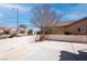 View of a quaint patio with a fountain, surrounded by neighboring houses and blue skies at 3025 Treesdale Dr, Las Vegas, NV 89134