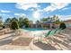 Outdoor pool area featuring chaise lounge chairs, umbrellas, and a well-maintained concrete deck at 3025 Treesdale Dr, Las Vegas, NV 89134