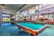 Large recreation room features billiard tables, large windows and hanging pendant lights at 3025 Treesdale Dr, Las Vegas, NV 89134