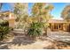 Well landscaped backyard featuring mature trees, built in grill, and covered patio at 3163 Elk Clover St, Las Vegas, NV 89135