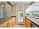 Bar area leading to sunroom, with granite countertops, natural light and wooden cabinets at 3163 Elk Clover St, Las Vegas, NV 89135