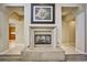 Stone fireplace with hearth and decorative artwork above, between two entries at 3163 Elk Clover St, Las Vegas, NV 89135