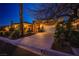 Well-maintained home exterior featuring a wide driveway, two-car garage, and mature desert landscaping at 3163 Elk Clover St, Las Vegas, NV 89135