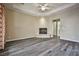 A living room with wood flooring, fan, and fireplace, with a view to other rooms at 3163 Elk Clover St, Las Vegas, NV 89135