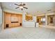 Open living room with custom built-ins, tile flooring, and stainless steel appliances at 3163 Elk Clover St, Las Vegas, NV 89135