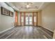 Spacious main bedroom featuring wood floor, tray ceiling, fan and french doors to the backyard at 3163 Elk Clover St, Las Vegas, NV 89135