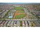 Panoramic aerial view showcasing a Primary-planned community with sports fields and community pool at 3167 Biccari Ave, Henderson, NV 89044