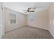 A well-lit bedroom with plush carpet and two windows at 3167 Biccari Ave, Henderson, NV 89044