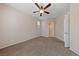 Neutral bedroom featuring plush carpet, fan, and view of the en-suite bath at 3167 Biccari Ave, Henderson, NV 89044