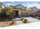 Inviting two-story home featuring a meticulously landscaped front yard and a convenient two-car garage at 3167 Biccari Ave, Henderson, NV 89044