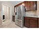 Kitchen with stainless steel refrigerator and modern dark wood cabinetry at 3167 Biccari Ave, Henderson, NV 89044