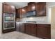 Kitchen with stainless steel appliances, double ovens, gas range and dark wood cabinetry at 3167 Biccari Ave, Henderson, NV 89044