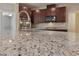 Close up of granite countertop, dark wood cabinetry, stainless steel appliances in kitchen at 3167 Biccari Ave, Henderson, NV 89044