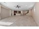 Spacious living room with tile flooring, ceiling fan, and access to kitchen and staircase at 3167 Biccari Ave, Henderson, NV 89044
