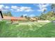 Expansive backyard features a sparkling pool, lush lawn, and mature trees, offering ample space for outdoor activities at 3221 Montecito Dr, Las Vegas, NV 89120