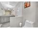 Bright bathroom features a gray vanity with double sinks and a white toilet at 3221 Montecito Dr, Las Vegas, NV 89120