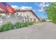 Long driveway leads to a home with a well-maintained exterior, showcasing desert landscaping and an American flag at 3221 Montecito Dr, Las Vegas, NV 89120