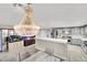 Open concept kitchen features an oversized island, stainless appliances, and modern hanging lights at 3221 Montecito Dr, Las Vegas, NV 89120