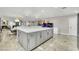 Open kitchen with gray cabinets, and a large central island for dining and entertaining at 3221 Montecito Dr, Las Vegas, NV 89120