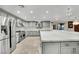 Spacious kitchen showcases stainless steel appliances, gray cabinets, an island, and granite counters at 3221 Montecito Dr, Las Vegas, NV 89120