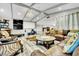 Spacious living room with a large leather sofa, wet bar, projector, and unique decor at 3221 Montecito Dr, Las Vegas, NV 89120