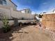 The spacious backyard features a perimeter of masonry walls providing privacy; ready for customization and landscaping at 3673 Spring Day Ct, Las Vegas, NV 89147