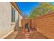 Private backyard area features low-maintenance landscaping and a brick wall for added seclusion at 3685 Australian Cloud Dr, Las Vegas, NV 89135