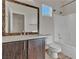 Bathroom featuring dark wood cabinets, decorative mirror, shower-tub, and toilet at 3685 Australian Cloud Dr, Las Vegas, NV 89135