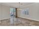 Elegant dining room with tile floors, decorative chandelier, and sliding doors to the outdoor area at 3685 Australian Cloud Dr, Las Vegas, NV 89135