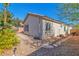 Exterior shot of a home with desert landscaping and a stone path to the backyard at 3685 Australian Cloud Dr, Las Vegas, NV 89135