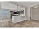 Open-concept kitchen with a breakfast bar, dark wood cabinets, pendant lighting and tile flooring at 3685 Australian Cloud Dr, Las Vegas, NV 89135