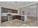Modern kitchen featuring stainless steel appliances, dark wood cabinets, and white countertops at 3685 Australian Cloud Dr, Las Vegas, NV 89135