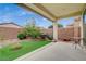 A backyard offers a serene retreat with artificial turf, landscaping, and a covered patio at 3717 Rocklin Peak Ave, North Las Vegas, NV 89081