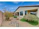 Well-maintained backyard showcasing desert landscaping, artificial turf, and a patio at 3717 Rocklin Peak Ave, North Las Vegas, NV 89081