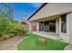 Charming backyard with a covered patio, artificial turf, and a citrus tree at 3717 Rocklin Peak Ave, North Las Vegas, NV 89081